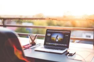 Freelancer working at a laptop outdoors - freelancer vs. starting a website design company